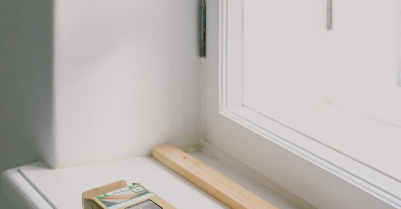 Power Hammer - Hammer with wooden handle near plank and cardboard box on windowsill in light house