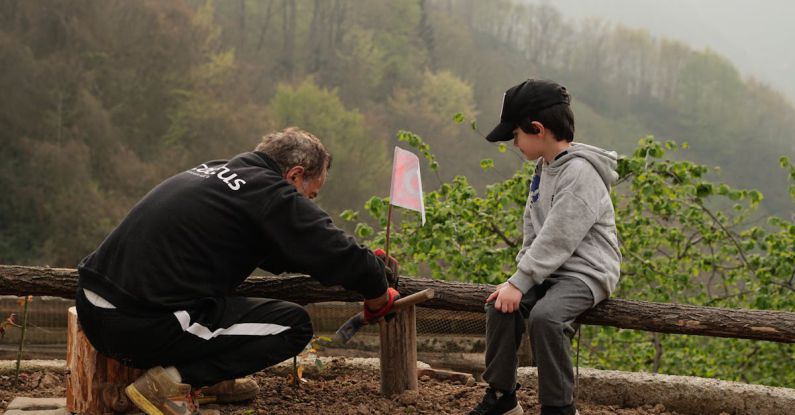 Treadle Hammer - Man with Boy Leaving Flag in Foggy Autumn Countryside