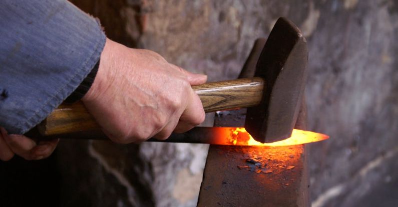 Forge - Person Holding Forging Metal