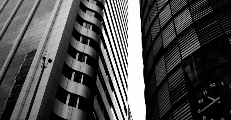 High-Carbon Steel - Black and white photo of two tall buildings