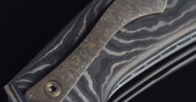 Damascus Steel - A knife with a black and silver handle