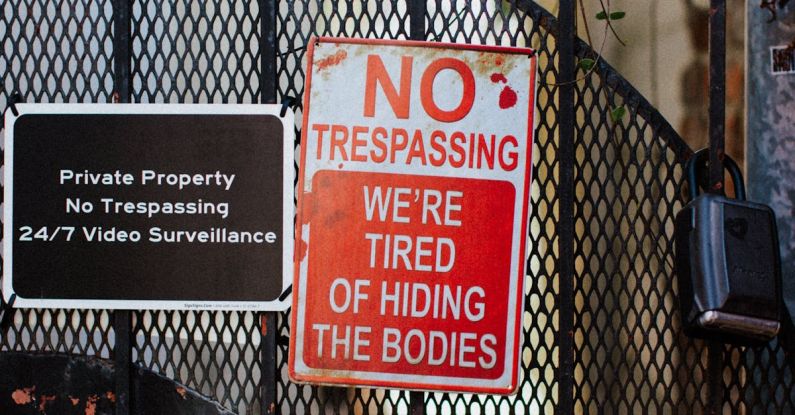 Wrought Iron - Red Warning Sign on a Metal Gate
