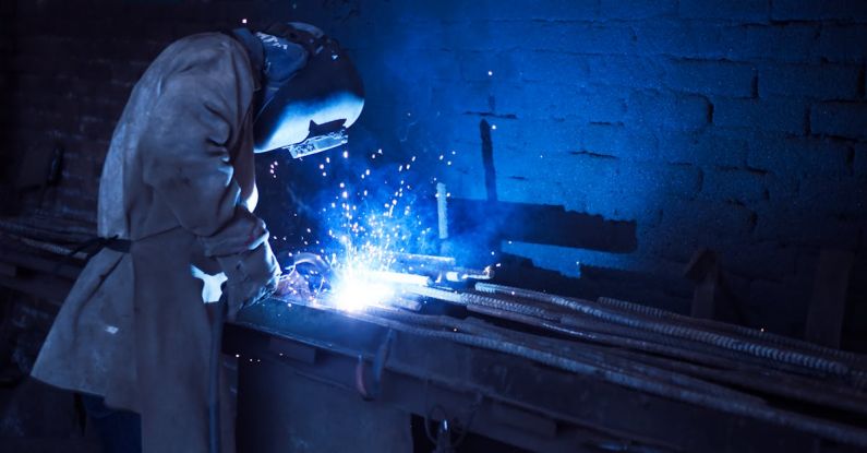 Metalwork - Man Wearing Welding Helmet Welding Metal Near Gray Brick Wall