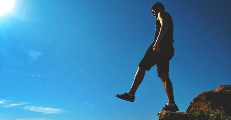 Edge - Man Standing on Cliff
