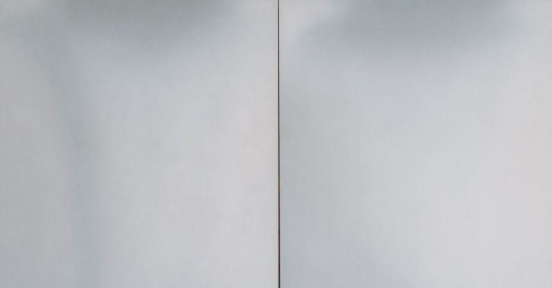 Finishing - Full frame background of white textured wall with simple finishing panels and lines of modern residential building located on street