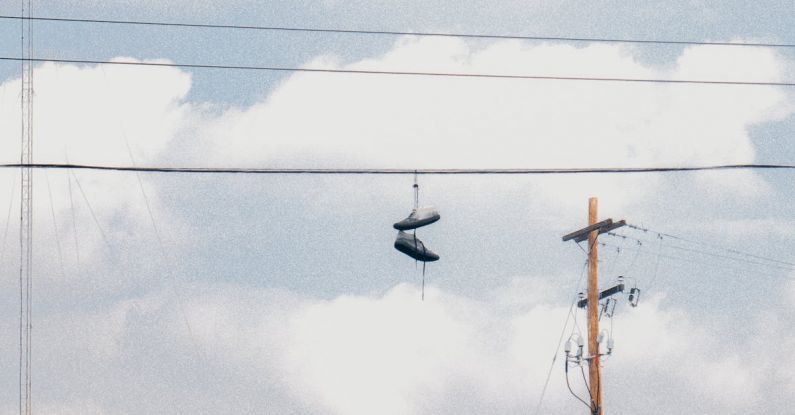 Aesthetic - Pair of Shoes Hanging on Electric Wire