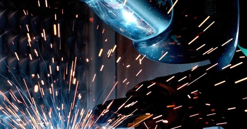 Metals - Person in Welding Mask While Welding a Metal Bar